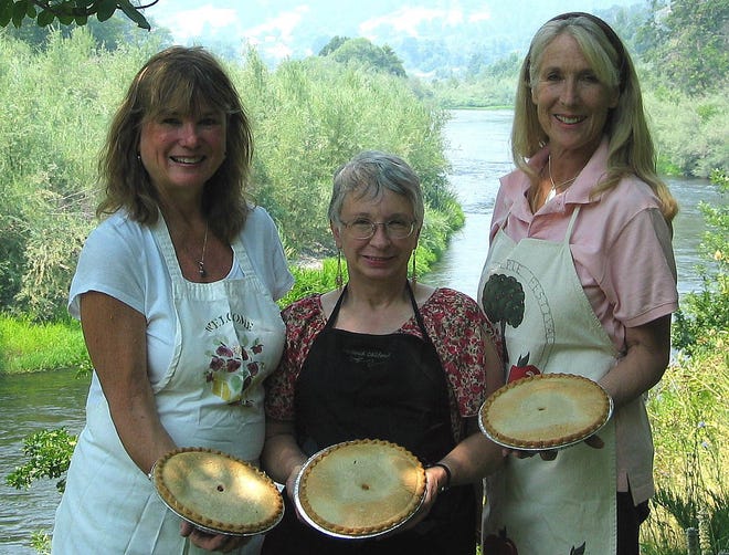 Klamath River Volunteer Fire Company Auxiliary members, from left, Sara Letton, Colleen Reber and Nancy Schaeffer, pose with a few of the 75 blackberry pies sold at last year’s festival.