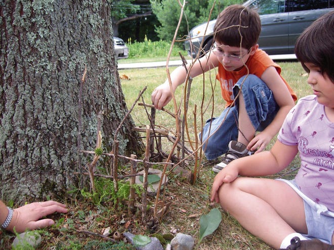 Jack and Sophie Reposa of Rehoboth create fairy houses as part of the program at the Rehoboth library.