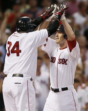Jason Bay (right) is congratulated by David Ortiz after hitting a home run in the first inning of the Red Sox' 12-2 win over the A's.