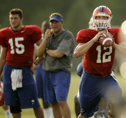 Trinity Catholic graduate John Brantley (12) is seen with Florida starting QB Tim Tebow (15) and coach Dan Mullen during last year's fall practice. Brantley redshirted last season and was sidelined most of the spring with injuries, but hopes to earn the backup QB spot this year.