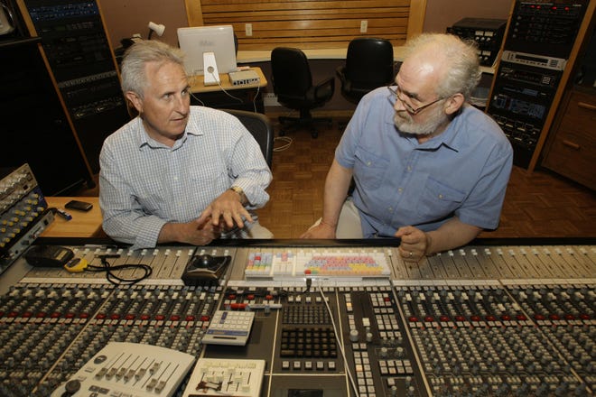 John Giaier, left, and Bill Gildenstern work at a sound-mixing board during a recent interview at a studio in Dearborn Heights, Mich. Giaier and Gildenstern created “The Rosary Tapes,” a collection of Roman Catholic prayers and meditations for the rosary set to contemporary music.