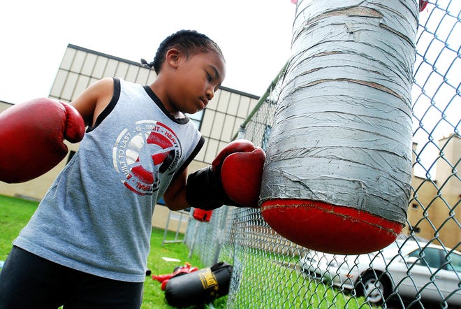 Sincere Goico, 7, of Utica, punches a bag during Boxing Youth Sports Camp Monday, Aug. 4, 2008, at Martin Luther King Jr. Elementary School in Utica.