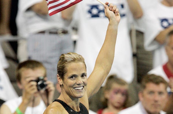Dara Torres, 41, waves the flag after qualifying for her fifth Olympics at swimming trials in Nebraska last month.