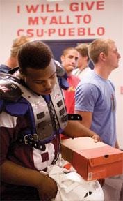 CHIEFTAIN PHOTO/BRYAN KELSEN Colorado State University-Pueblo freshman football player Darren Brown, a defensive lineman from Overland High School in Aurora, goes through the equipment line during check-in Wednesday for the ThunderWolves football program.