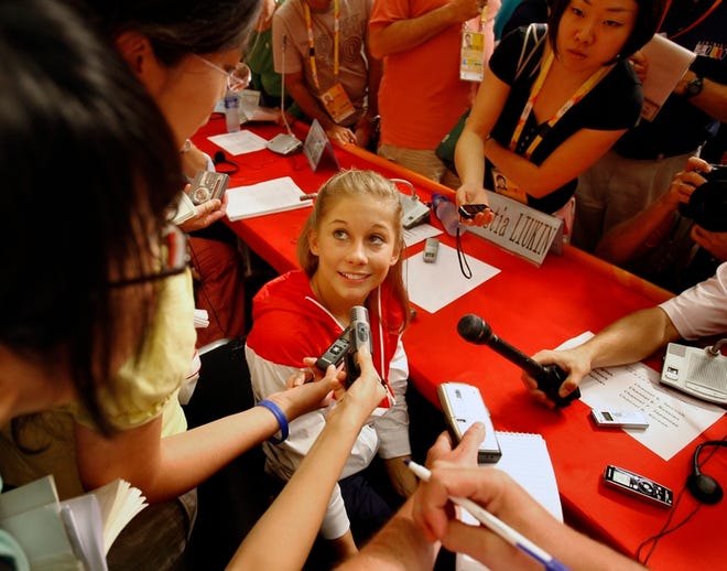 U.S . women's gymnast Shawn Johnson fields questions from reporters from around the world during a press conference at the main press center in Beijing on Thursday.