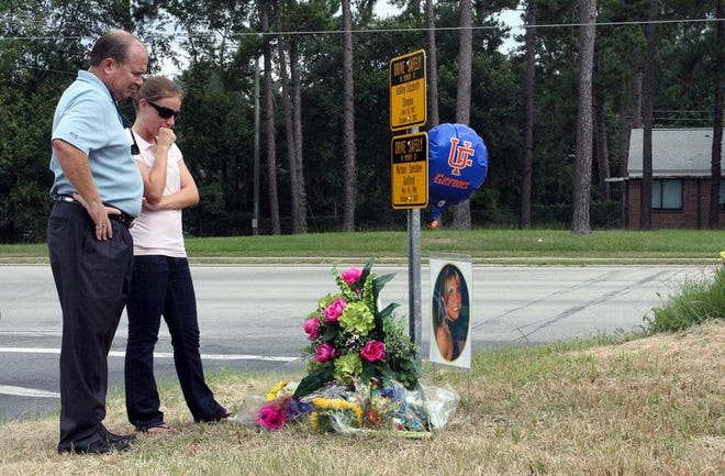 Jim Slonina and Slonina family friend Holly Williamson spent a few quiet moments reflecting after the dedication of the traffic memorial erected on a Gainesville roadside. The memorial recalled the death of Slonina's daughter, Ashley, and her friend, Michael Guilford, south of Archer Road.