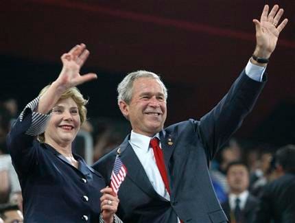 U.S. President George Bush and his wife Laura wave during the Beijing 2008 Summer Olympics opening ceremony in Beijing, Friday, Aug. 8, 2008. Bush met with several U.S. athletes and then headed to the Olmypic mountain bike course to take a spin.