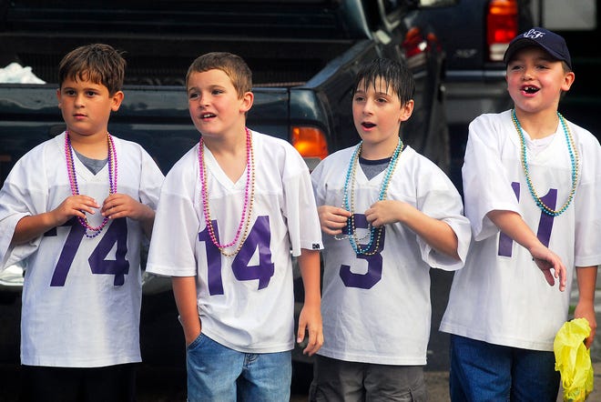 Left to right, Little Falls Pop Warner members Alex Liscio, 10, Patrick Reardon, 8, Nathan Miller, 10, and Jake Wheet, 9, watch as floats pass by during the Little Falls Canal Celebration parade down Albany Street, Friday, August 8, 2008 in Little Falls.