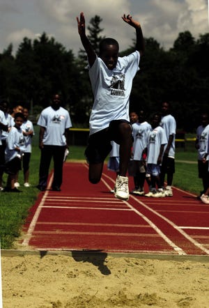 D'Andre Merren, 10, competes in the long jump during the Bridgewater State College's own Olympics held on campus Friday.