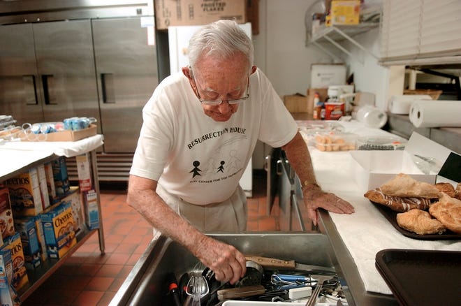 STAFF PHOTO / E. SKYLAR LITHERLAND / 
elaine.litherland@heraldtribune.com
Ray Grills, a longtime volunteer at the Resurrection House in Sarasota, 
fishes for a knife Wednesday as he helps get breakfast ready for some of the 
area's homeless people.