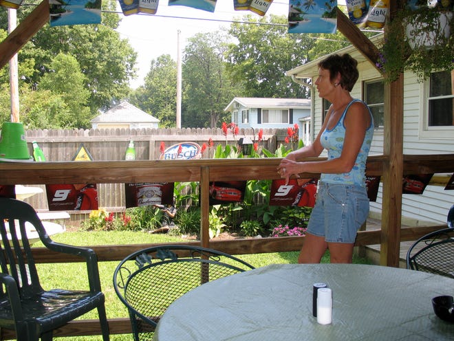 Family, food and fun: Belinda Jackson stands on the outside deck at Bldg. G Bar and Grill in Mossville. The restaurant is open seven days a week.