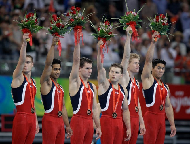The U.S. men's gymnastics team celebrates its bronze medal on Tuesday.