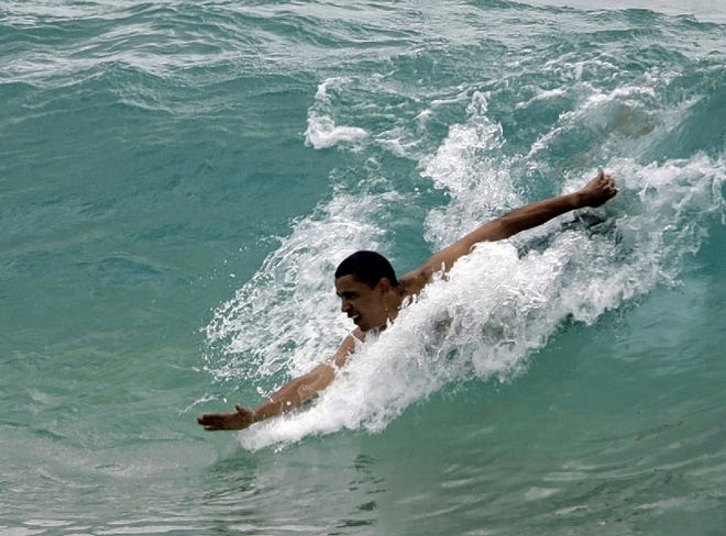 Democratic presidential candidate Sen. Barack Obama, D-Ill., body surfs at Sandy Beach in Honolulu, Hawaii, Thursday, Aug. 14, 2008. Sen. Obama is in Hawaii for a vacation. (AP Photo/Alex Brandon)