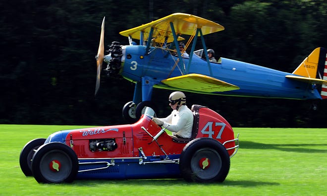 Somehere between 75 and 100 mph, driver Bruce Harrison of Hudson in a 1937 Walts Offy-powered sprint car pulls away from a PT-17 airplane piloted by Harvard resident Rob Collings, previewing one of the Race of the Century races this weekend at the Collings Foundation.