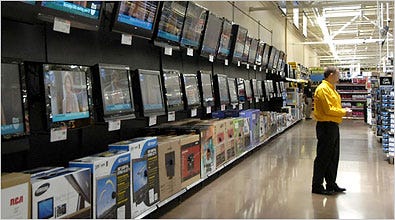 Flat screen televisions line the wall at a Wal-Mart Store in Rogers, Ark. Retail sales fell in July to the lowest level in five months.