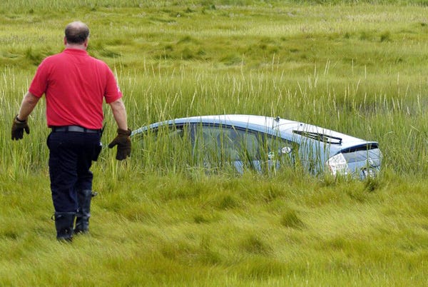 The scene after a car sailed into an Eastham marsh this morning. The driver was uninjured.
