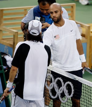 James Blake of the United States, right, congratulates Fernando Gonzalez of Chile after Gonzalez defeated Blake in a men's singles semifinal tennis match in the Olympics in Beijing on Friday.