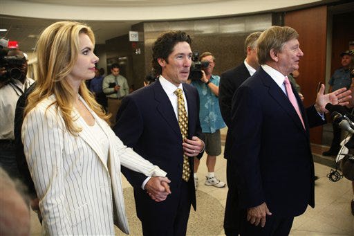 Rusty Hardin,right, attorney for Lakewood Church co-pastor Victoria Osteen, left,and her husband, Joel Osteen, center, share their reactions after the jury found that Victoria Osteen had not committed an assault against Continental Airlines flight attendant Sharon Brown in district court, in the Harris County Civil Courthouse. Thursday, Aug. 14, 2008, in Houston.