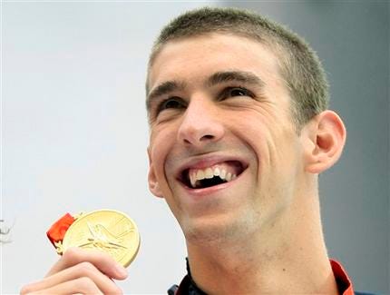 In this Aug. 15, 2008 file photo, Michael Phelps of the United States with his gold medal in the men's 200-meter individual medley during the swimming competitions in the National Aquatics Center at the Beijing 2008 Olympics in Beijing.