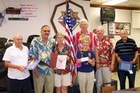Grand Knight Chris Eirich, third from right, presented the Knights of Columbus Council 7091's Knight of the Month and Family of the Month awards for the months of July and August. The event highlighted a Hawaiian-themed dinner at the Knights of Columbus Hall. Pictured with Eirich, from left to right, are Carmine Spiridigliozzi, John Tardif, Angie Tardif, Ellie Connell, Bob Connell and Frank DiLeo.