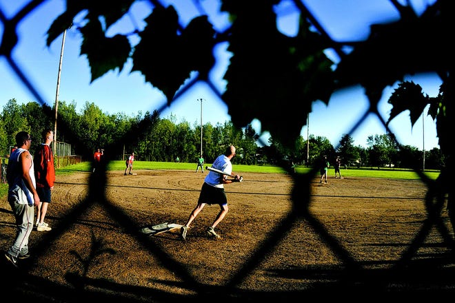 Constantino’s Scott Rowles watches his ball fly into the outfield as he gets ready to head to first in the championship game of the Canandaigua Men's Softball League.