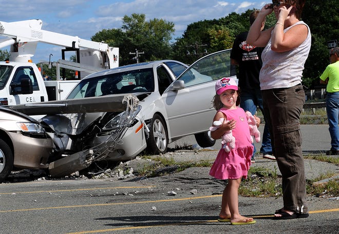 Sarah Diamond, 4, waits while her mother, Rachel Diamond of Southborough talks on the cell phone after a car struck her minivan and two other parked cars yesterday while they were in the post office at 855 Trolley Square in Framingham.