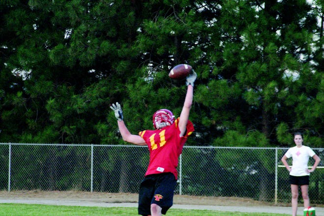 Yreka High's number 11 jumps for a one-handed catch at practice.