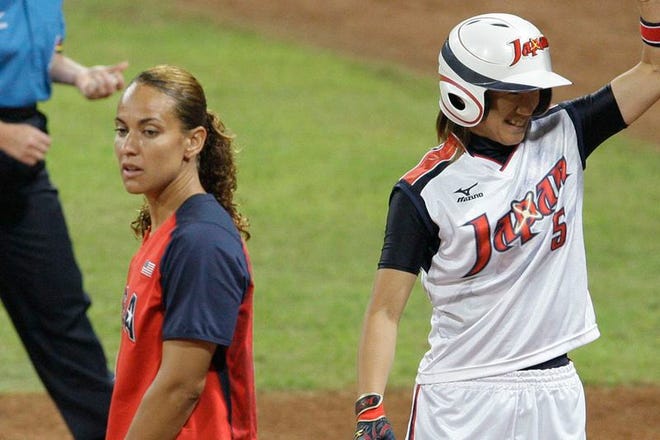 Japan's Ayumi Karino cheers after her base hit scored a run as USA first baseman Tairia Flowers stands near in the gold medal softball game in the Beijing 2008 Olympics in Beijing, Thursday, Aug. 21, 2008.