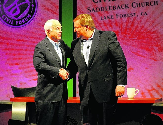 THE REV. RICK WARREN greets Republican presidential candidate John McCain for a televised forum on faith and character. Warren also interviewed Democratic candidate Barack Obama.