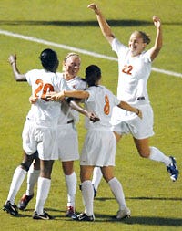 Illinois' Laura Knutson (22) heads toward the group hug after Chichi Nweke (20) scored in overtime to lift the Illini over Missouri 2-1.
