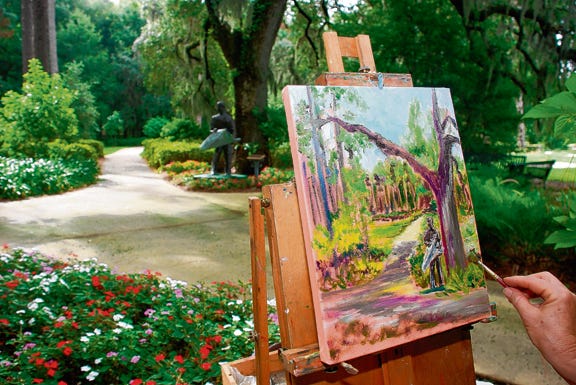The great outdoors: Local artist Diana Crow paints under the live oaks in the back area of Sholom Park in Ocala. She is a member of the
Ocala Plein Air Painters, a group of about 18 artists who get together the first Saturday of each month to paint on location around the county.