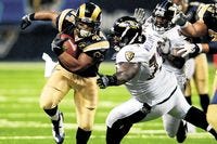 St. Louis Rams running back Lance Ball, left, races past Baltimore Ravens' Lorenzo Williams during the fourth quarter of an NFL preseason football game Saturday, Aug. 23, 2008, in St. Louis.