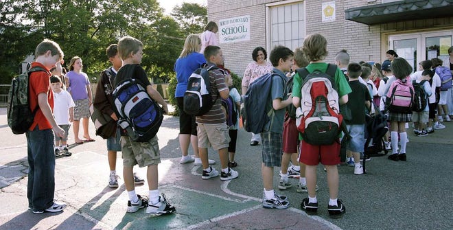 Students wait outside the North School in Abington on Tuesday, which was the first day of the new school year.