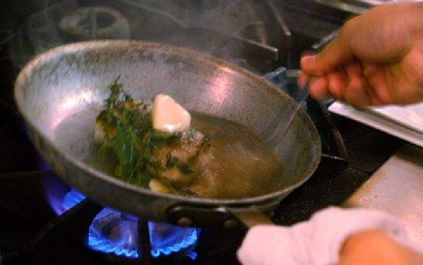 Chef Bill Brodsky sautees a piece of halibut in butter and herbs over a gas range. 10/8/02 steve heaslip 
Chef Bill Brodsky sautees a piece of halibut in butter and herbs over a gas range. 10/8/02 steve heaslip