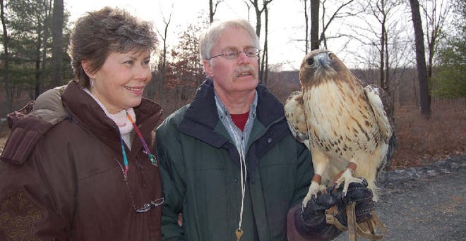 In keeping with the Pike County Public Library's focus on conservation issues, the community picnic on Saturday, September 6 will include a special demonstration of birds of prey by the Delaware Valley Raptor Center. Pictured are Stephanie and Bill Streeter of the Raptor Center with a red-tailed hawk named Neekahna. Photo courtesy Heron's Eye Communications.