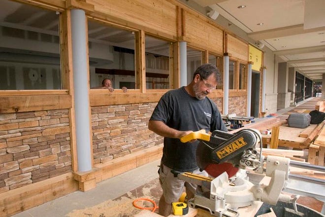 Dean Clements of C.N. Bailey & Company, Inc., cuts lumber for the front of the future Kobe Japanese Steakhouse restaurant at Midtown Village shopping center Monday.