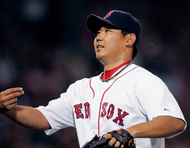 Daisuke Matsuzaka tosses the ball into the stands at the end of the fourth inning of Friday night's 8-0 win over the White Sox at Fenway Park.
