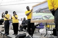 Charles and Judith Anderson, left, co-pastors at Trinity Worship Center, and church staff unveil an architects drawing of the new Youth Enrichment Complex during a groundbreaking ceremony on Saturday at the corner of Recker Highway and 21st Street, S.W. in Winter Haven. Saturday August 30, 2008