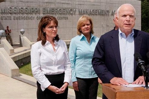 Republican presidential candidate Sen. John McCain, R-Ariz., announces there will be changes to the Republican National Convention due to Hurricane Gustav during a media availability outside the Mississippi Emergency Management Agency in Pearl, Miss., on Sunday. Vice presidential running mate Alaska Gov. Sarah Palin, left, and Marsha Barbour, wife of Mississippi Gov. Haley Barbour listen.