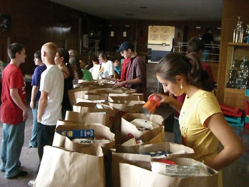 Coyle-Cassidy senior Lauren LeClair fills bags SAturday for nearly 300 needy Taunton residents.