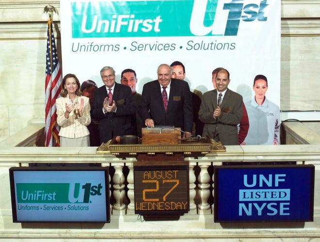 UniFirst President and CEO Ronald Croatti rings the closing bell on the New York Stock Exchange Wednesday to commemorate the company\u2019s 25th year of being listed on the exchange. Pictured (from left) are: Noreen Culhane of the NYSE; John Bartlett, UniFirst chief financial officer; Croatti; and Steven Sintros, UniFirst corporate controller. UniFirst is a leading supplier of uniforms and work clothing to more than 200,000 business customers throughout the U.S. and Canada and maintains a facility in Rincon.