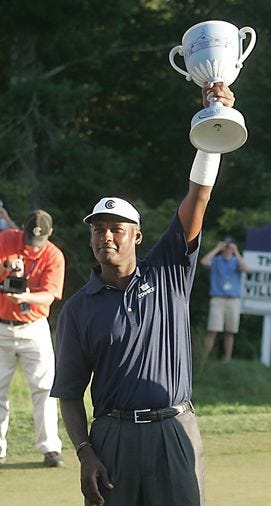 Vijay Singh holds up the trophy for winning his second Deutsche Bank Championship Sunday in Norton