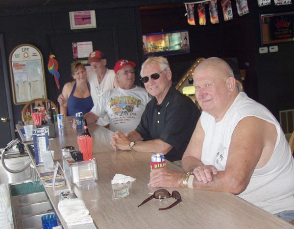 Patrons enjoy a place to eat and drink at the newly reopened Bikini’s Sand Bar in Keithsburg.