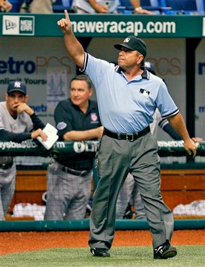 Umpire crew chief Charlie Reliford signals that New York Yankees' Alex Rodriguez's hit off Tampa Bay Rays' Troy Percival is a home run, after an instant-replay review during the ninth inning of a baseball game Wednesday, Sept. 3, 2008, in St. Petersburg, Fla.