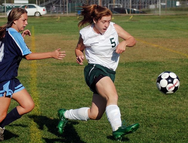 Whaley/Democrat photo
Dover's Bridget Lynch, right, pushes the ball past Nashua North's Haley Smith during Friday's Class L game in Dover. Lynch scored four goals in a 9-1 win.