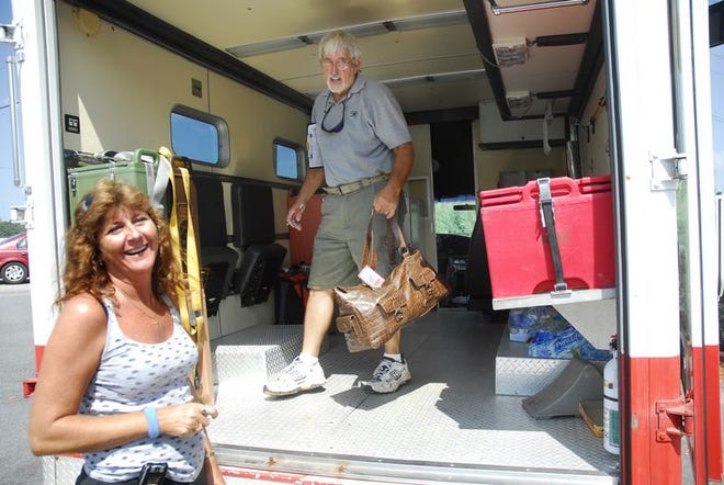 Joe and Janet Uldrick, volunteers for the Piedmont Chapter of the American Red Cross, pack an 
emergency response vehicle Friday to provide aid to areas affected by Tropical Storm Hanna.