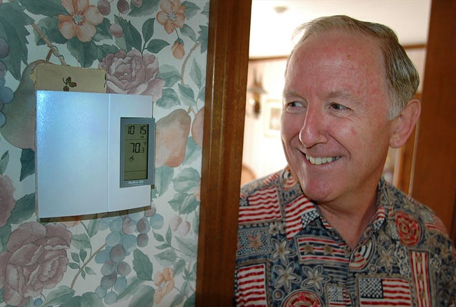 Richard Connolly of Weymouth replaced his pellet stoves with a high-efficiency electric heating unit. He says his heating expenses have been lower since the switch.