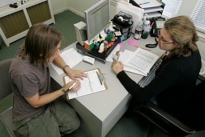 Robert Wittke, left, who has been looking for full- or part-time work for about two months, talks with Jennifer Kaminsky, manager of the Snelling Staffing Services, as he fills out an application for work in East Brunswick, N.J., on Friday. The nation’s unemployment rate bolted above the psychologically important 6 percent level for the first time in five years.