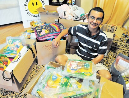 Joey Salmeron, 14, started "Project Smiles" raising money for backpacks full of coloring books and other fun things for pediatric patients, at home in Medway, Thursday.
