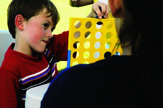 Brandon Hedges, 6, plays Connect Four during the Rollin’ Rec program in Tracy on August 28.